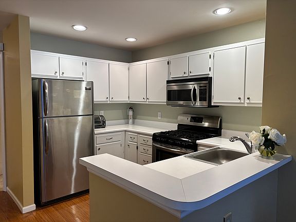 Kitchen with SS appliances, recessed lighting and H/W flooring
