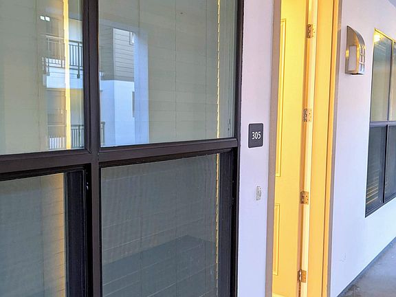 Very well-maintained condo hallway to home entrance