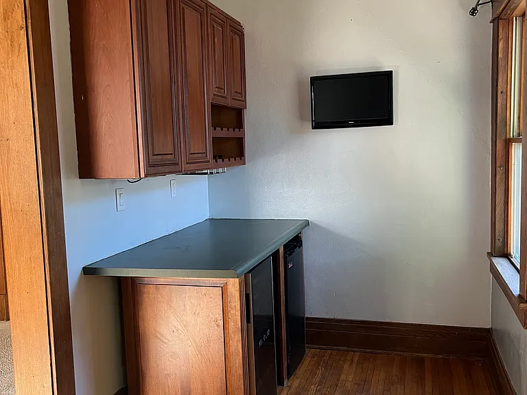 Main floor bar area with room under counter for a mini fridge or wine fridge