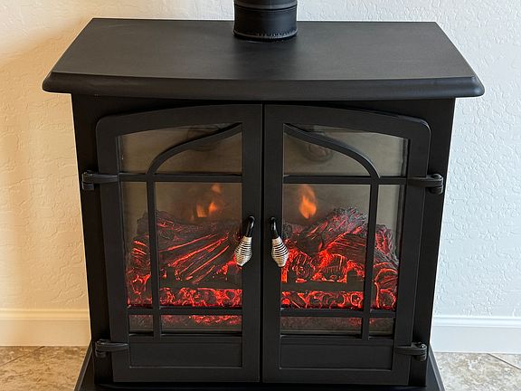 Free-standing electric fireplace with blower.
