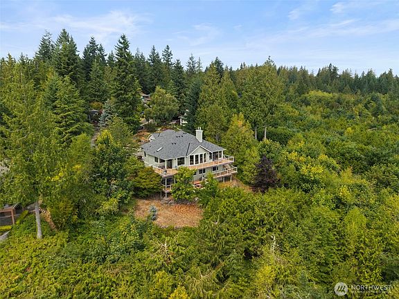 Sited on 3/4 acre, the home is surrounded by nature at it's finest; watch eagles soar and deer wander through.>