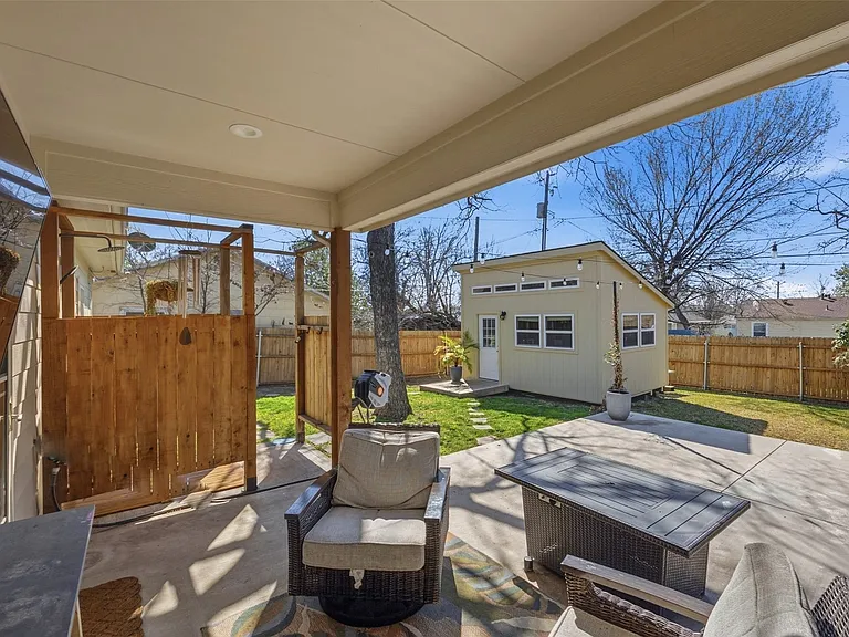 Covered patio featuring recessed lighting, a concrete slab, and a wood privacy screen