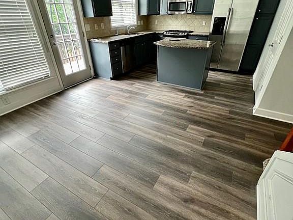 Dining and Kitchen - new floors and freshly painted cabinets!