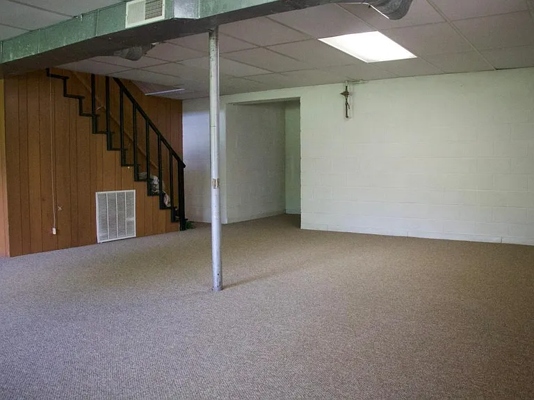 Large carpeted basement opens to garage.
