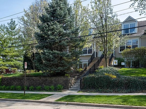 View of the home from the street with tons of green space