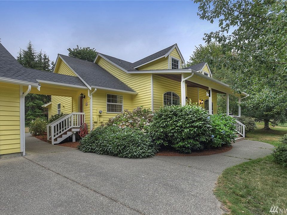 Front, showing covered breeze-way to over-sized 2 car garage