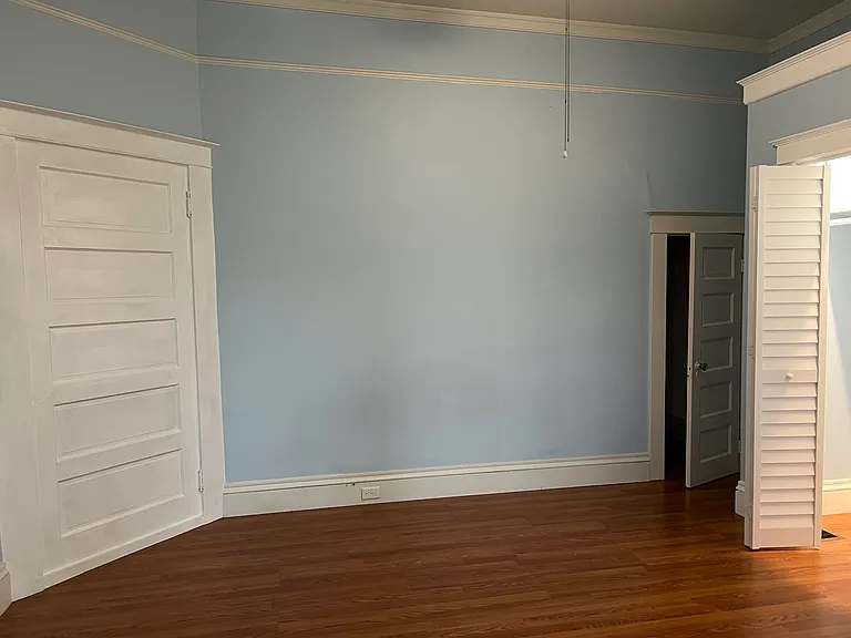 Spacious bedroom with high ceilings and three large closets