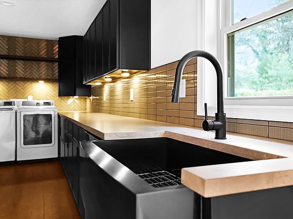 Undermount lighting and modern farm style sink.