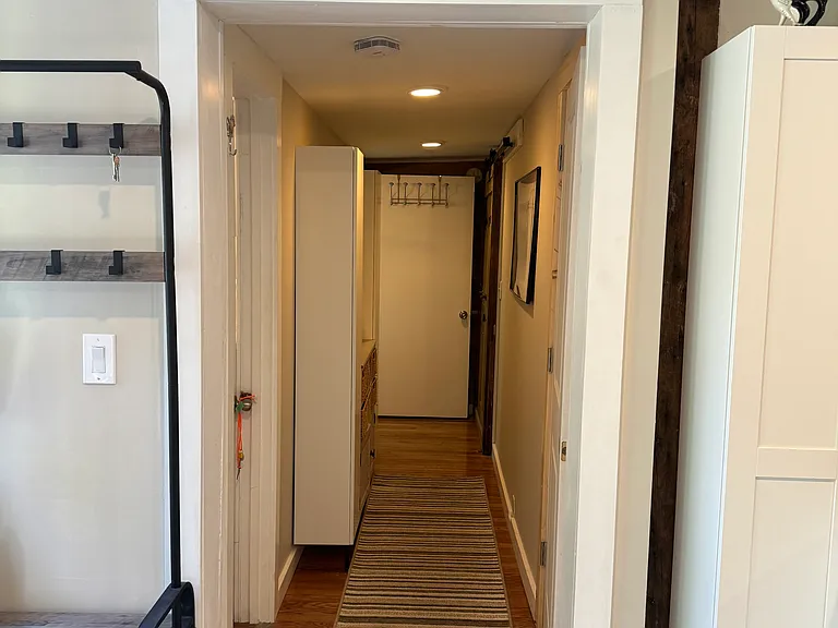 Hallway leads to new laundry room with full size W/D, 2nd bedroom and bathroom, and storage.