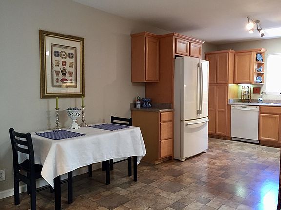 Spacious kitchen with cozy dining area. 