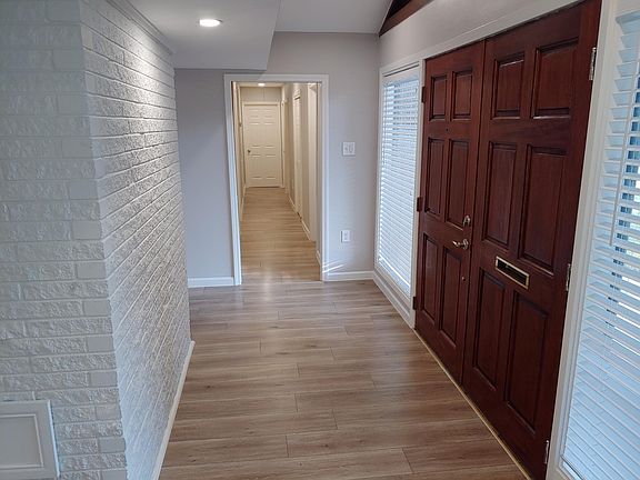 Front Door / Foyer Area
Front Door - to the right
Hallway entrance - straight ahead
Back of Fireplace (White Brick to the left with small door at bottom)