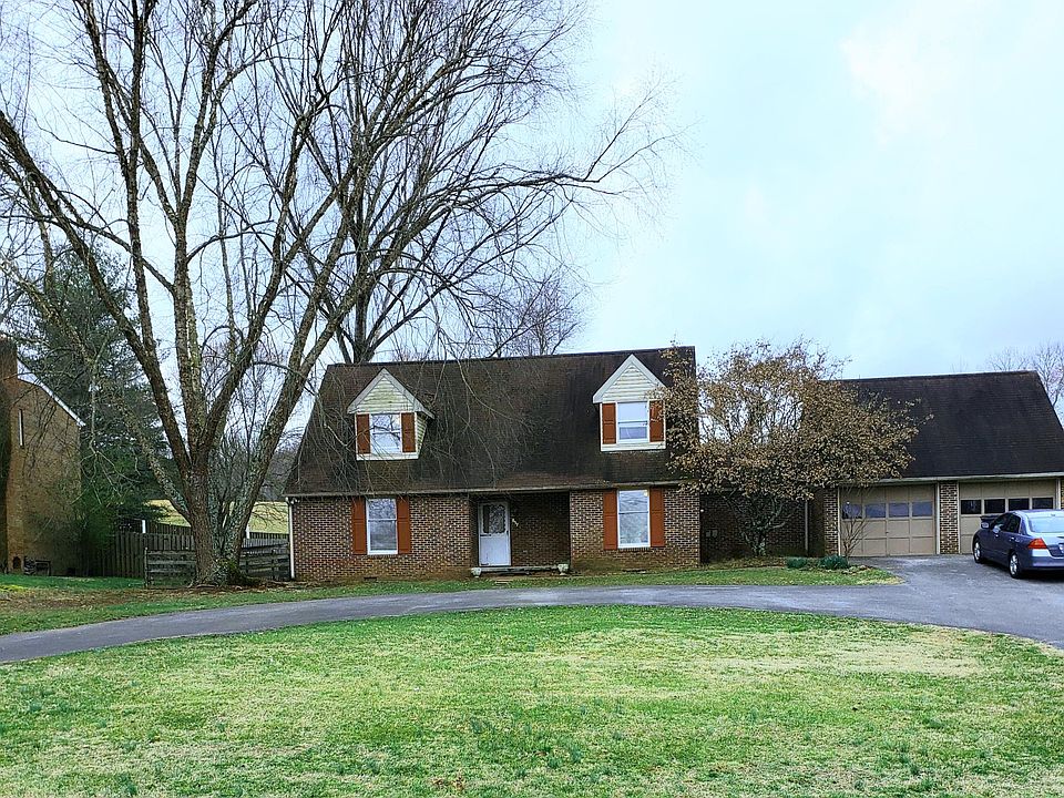 Exterior of the house, showing 2 car garage and circular in and out driveway