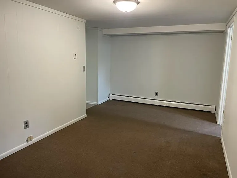 View from living room. Hall on left to kitchen/bathroom. Door on right is bedroom.
