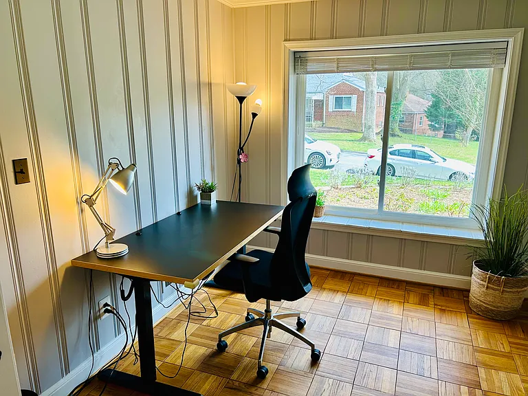 A fourth bedroom/den is filled with sunlight and opens directly to the living room. Currently set up as a home office. Also perfect as a kid's room, formal dining room, or family room.