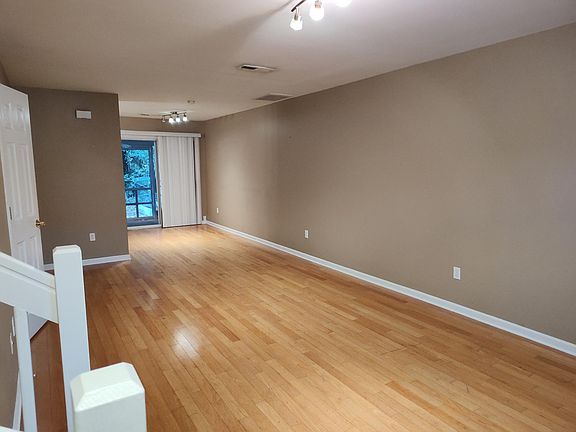 inside Front Door w/ stairs to the left looking at den & out to back porch.
