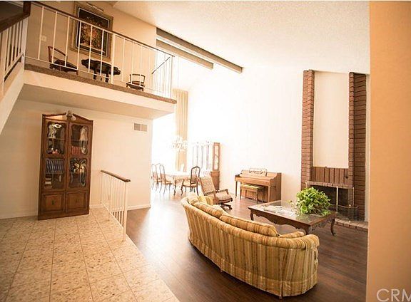 Entry to Living Room with Fireplace and Dining Room.