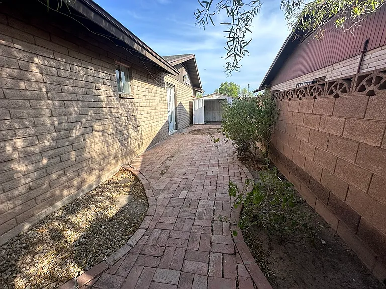 Private side yard and patio area w/ access from hallway bedroom