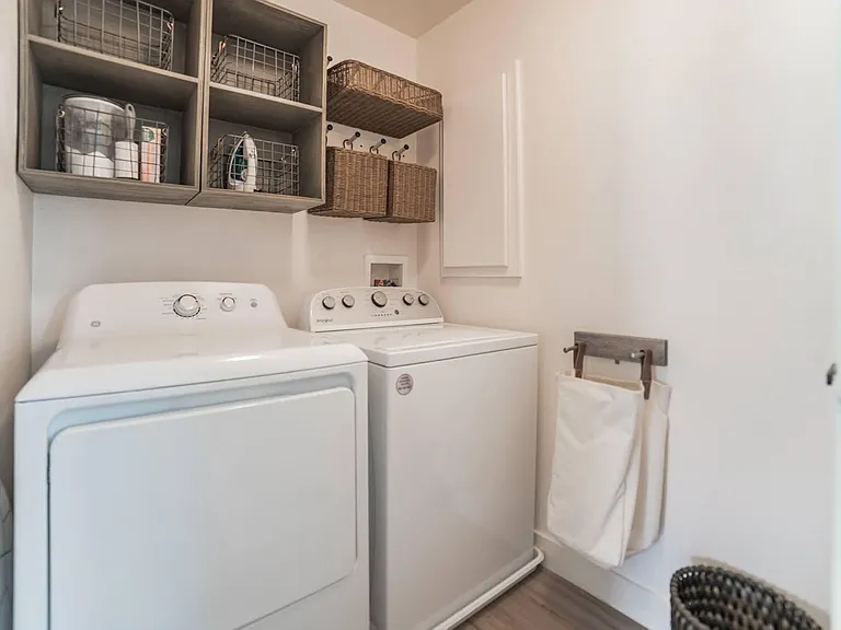 Washer and dryer on 2nd floor with storage, iron and ironing board