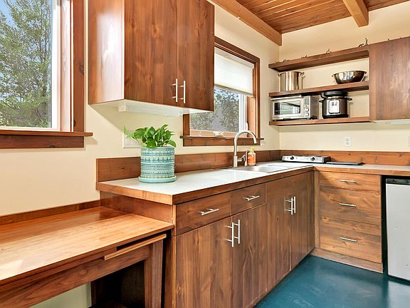 The kitchen is furnished with a fridge & freezer, 2 burner cook top, micro-oven, & instant pot.