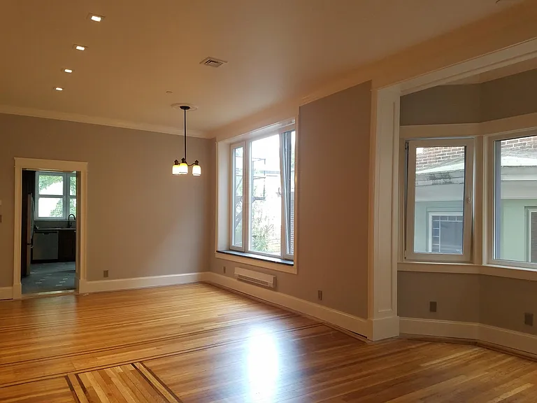 Large living-dining rm, exceptional light, and air. Deep stone sills, hardwood floors, recessed lighting,
