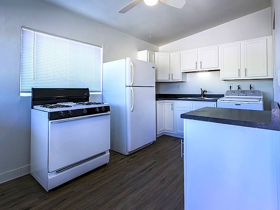 REFURBISHED KITCHEN WITH COZY BREAKFAST AREA TO THE LEFT OF STOVE - NEW FLOOR TILE ON 11/17/25. SEE FOLLOWING PIC.
