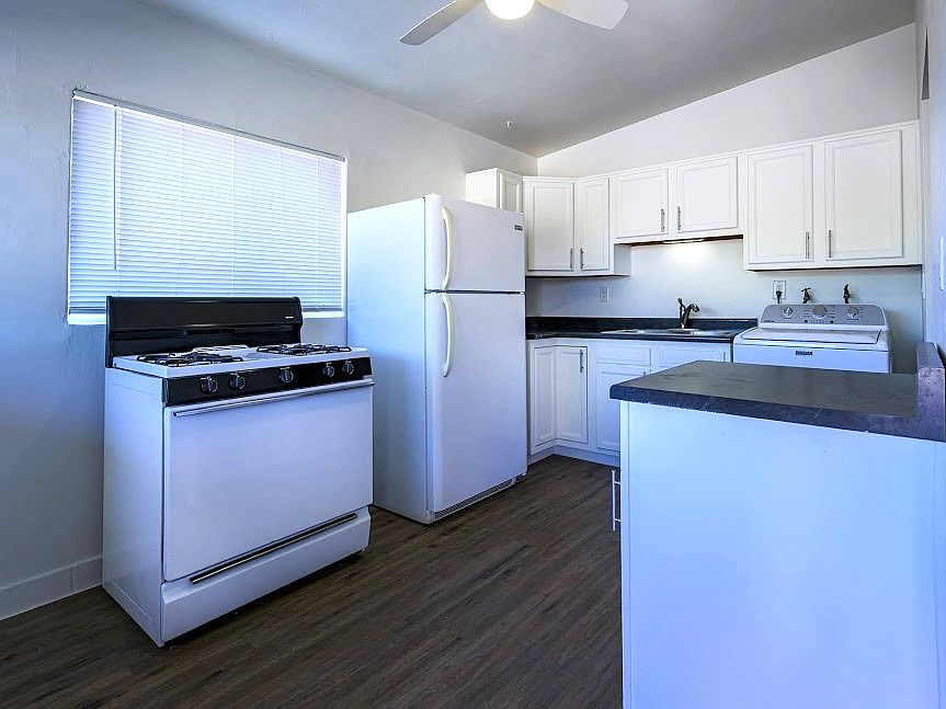 REFURBISHED KITCHEN WITH COZY BREAKFAST AREA TO THE LEFT OF STOVE - NEW FLOOR TILE ON 11/17/25. SEE FOLLOWING PIC.