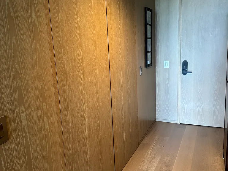 hallway entrance and left closet w washer and dryer and water heater