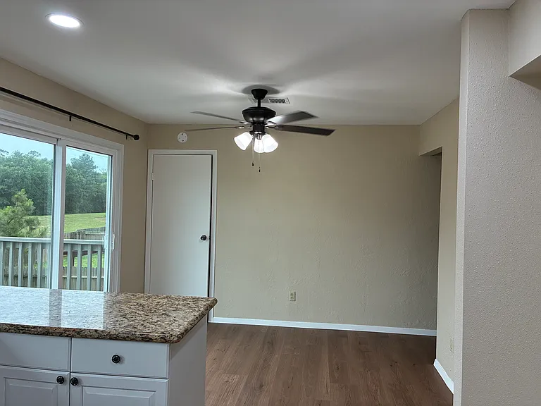 Breakfast area. Sliding door to upstairs deck