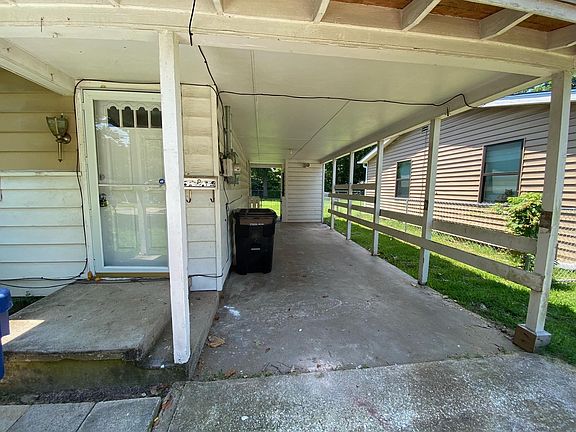 carport with small storage in the back of carport