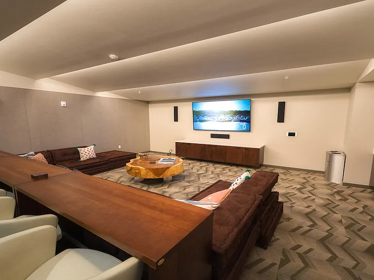 Media lounge with large screen and comfortable seating.