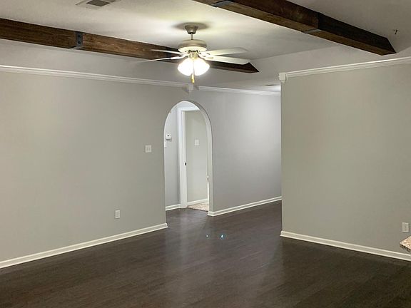 Living room looking into hall to spare bedrooms and bath