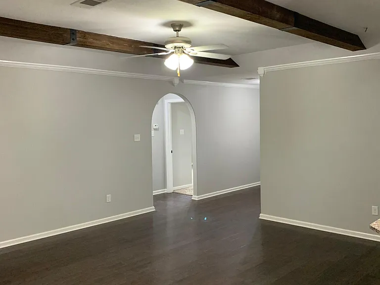Living room looking into hall to spare bedrooms and bath