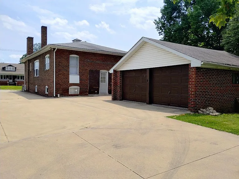 Concrete driveway that leads to the 2-car detached garage