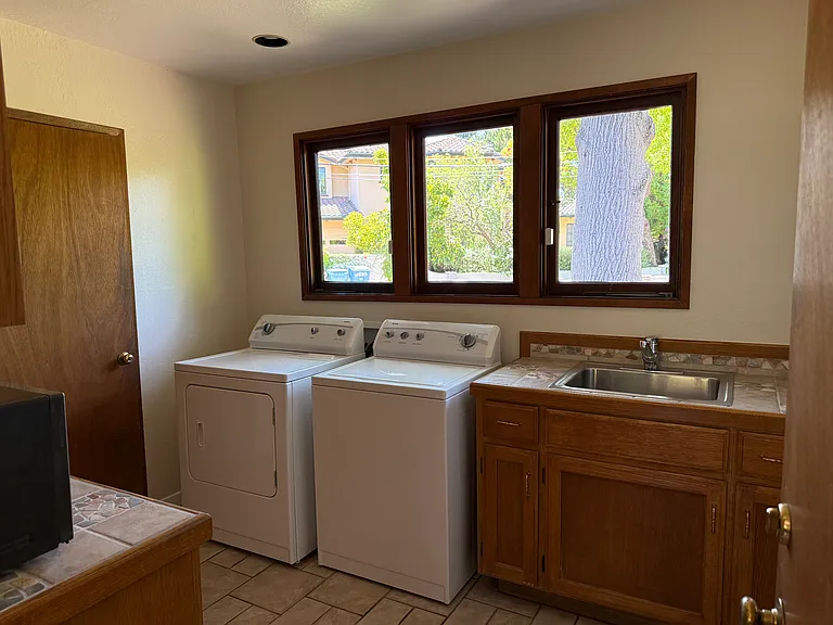 Laundry room with washer/dryer and sink.