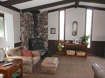 Very spacious family room offers freestanding Ben Franklin wood burning stove