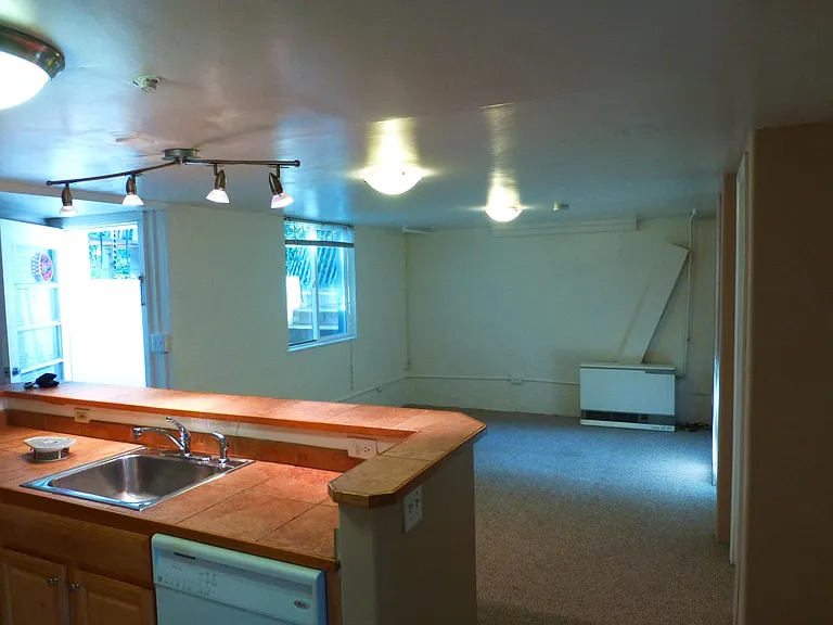 looking across kitchen to living area and entry