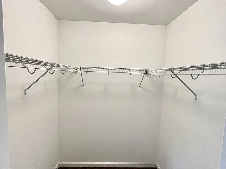 Primary bedroom walk-in closet