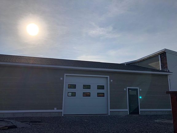 Unit 1 rear of building overhead door and single door entrance