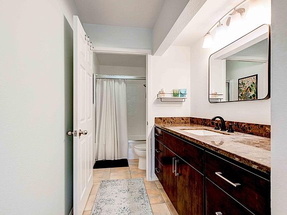 Large vanity in the master bathroom with shower/bath.