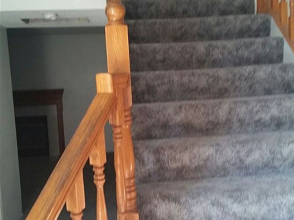 Carpeted Stairs with Carved Railings