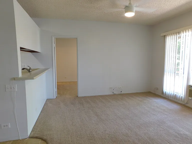 Living room separates two bedroom/bath suites. Living room has a ceiling fan and a window a/c.