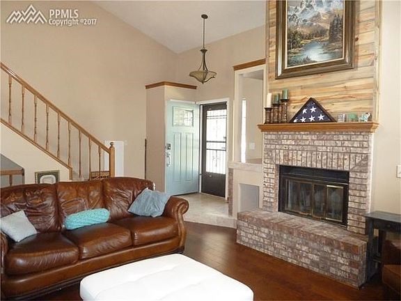 Warm and Inviting Living Room with Wood Burning Fireplace and lots of light