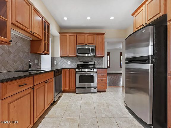 Full Kitchen with Dishwasher, Fridge, Microwave, Gas Range, with ample storage.