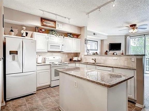 at top of stairs looking into kitchen and living room