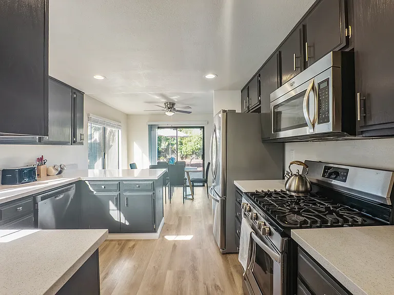 Enjoy cooking in the upgraded kitchen, complete with sleek granite countertops and a full suite of stainless steel appliances, including a refrigerator, range, microwave, and dishwasher.