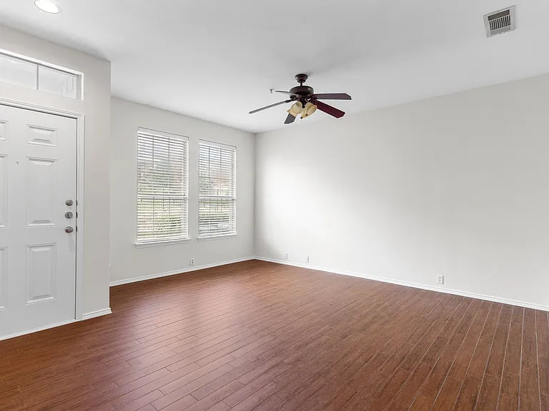 Natural Light abounds in the living room with laminate flooring.