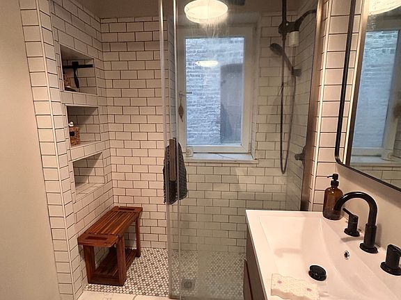 Recently renovated bathroom with custom tile work.
