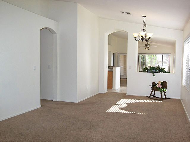 Welcoming living room with vaulted ceiling, plant shelf