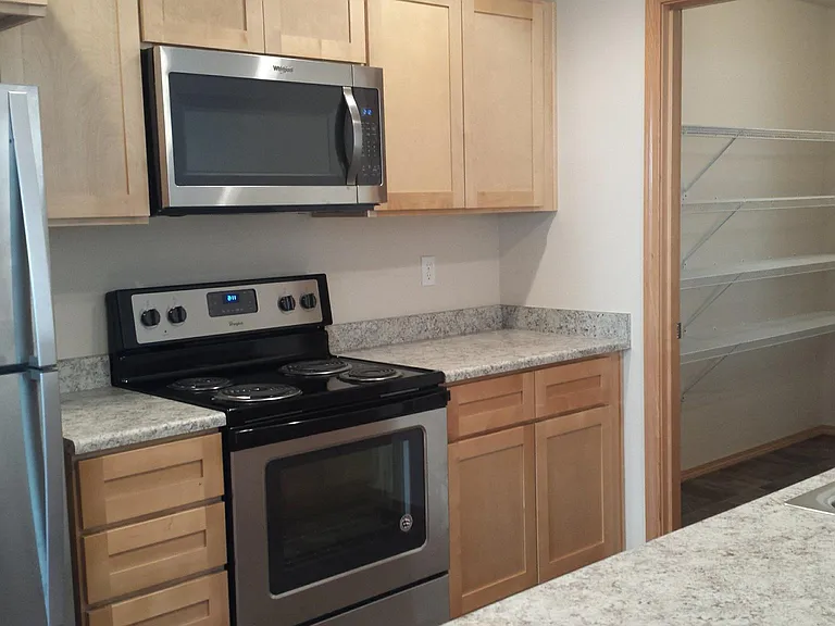 Stainless steel appliances, upgraded new stove/ range, dishwasher, garbage disposal, microwave, lots of cupboards.