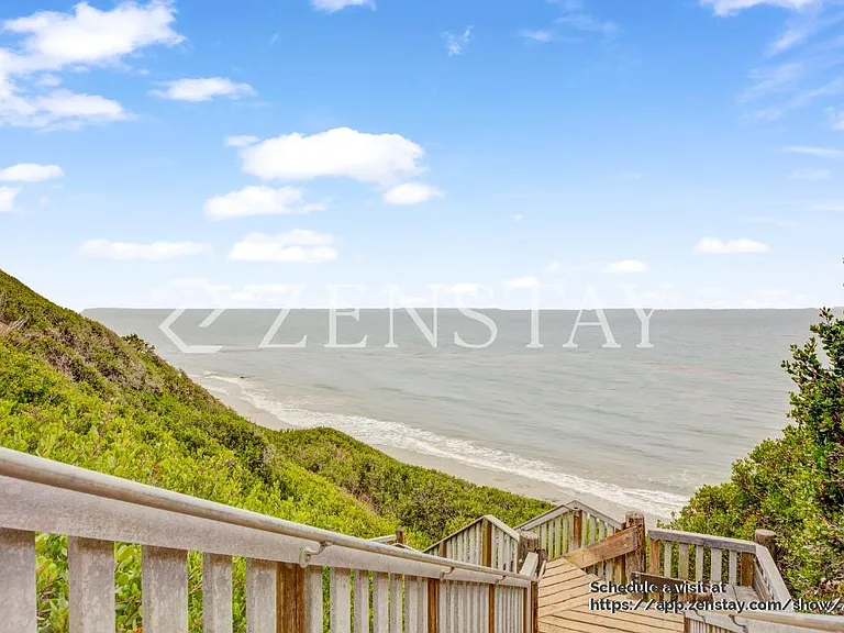 A walkway leads you directly from the backyard to the sandy shore